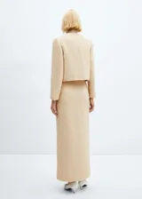 Falda larga color beige de tejido grueso con abertura delantera.