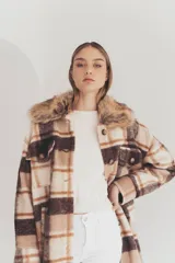 Tapado largo con estampado a cuadros en tonos marrón, beige y blanco. Presenta cuello con solapa y detalle de piel sintética.