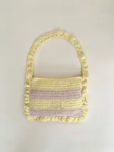 Cartera tejida a crochet con hilo 100% de algodón, con diseño a rayas y volados bordeando la cartera extendiéndose hacia la manija.
