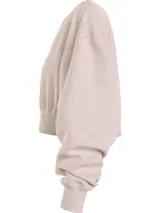 Buzo Calvin Klein Jeans color beige, de corte cropped, con cuello en V y logo bordado en el pecho.