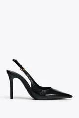Zapato de tacón negro con efecto relieve en el cuerpo, tira trasera con hebilla ajustable, tacón fino y acabado en punta.