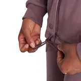 Campera Converse color malva, de corte recto, con cuello camisero, cierre frontal con broches a presión y logo de la marca en el pecho.