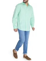 Camisa de manga larga celeste claro con cuello italiano y logo bordado en el pecho.