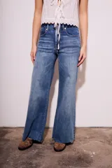 Pantalón de jean de tiro medio, color celeste, corte flared y wide leg.