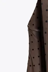 Vestido largo marrón con lunares negros, cuello halter ajustable, escote drapeado, espalda descubierta con tira ajustable y cierre lateral con cremallera oculta.