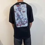 Remera negra de corte oversize con estampado rectangular en el pecho.