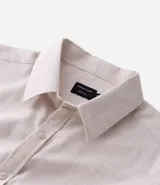 Camisa de manga larga para hombre, color gris oscuro con efecto melange, cuello inglés y botones frontales.