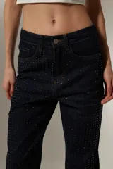 Pantalón de jean celeste con pequeños apliques brillantes.