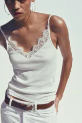 Camiseta negra de algodón con tirantes finos y escote en pico con detalle de encaje.
