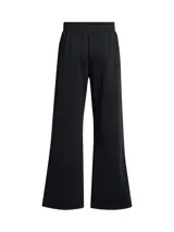 Pantalón deportivo Under Armour Icon Fleece para mujer, color negro, de corte holgado y pierna ancha, con cintura elástica ajustable con cordón, bolsillos laterales y logo estampado en la pierna izquierda.