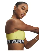 Top deportivo Under Armour color amarillo con banda elástica inferior con logo de la marca.