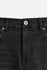 Pantalón de jean negro con corte skinny fit, cinco bolsillos, lavado con efecto roto y cierre frontal con cremallera y botón.