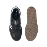 Zapatillas Adidas Samba con plataforma, color negro con las tres tiras blancas y suela marrón.