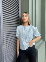 Blusa de algodón azul con detalles de bordado y mangas cortas.