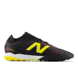 Championes de fútbol New Balance Tekela, color negro con detalles en amarillo y rojo, suela con tapones para césped sintético.