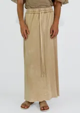 Conjunto color gris topo, compuesto por musculosa con cuello redondo y falda larga con cintura elastizada y cordón ajustable.