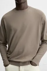 Jersey de punto azul marino de corte clásico, con cuello redondo y mangas largas.