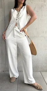 Conjunto color crudo compuesto por chaleco con botones y pantalón de lino.