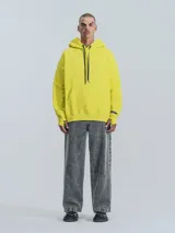 Hoodie amarillo neón de frisa premium con capucha ajustable, corte oversize, cintura y puños elastizados.