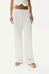 Pantalón recto blanco de punto con textura arrugada, cintura elástica y cordón ajustable.