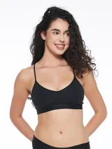 Top deportivo negro con breteles finos y espalda estilo nadador. Elástico ancho en la base con logo de la marca. Sin aro ni relleno.