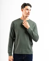 Remera de manga larga verde musgo confeccionada en tela tipo mini piqué de 100% algodón, con cierre de medio cuello y tres botones.