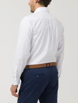 Camisa de vestir blanca de algodón, corte moderno ajustado al cuerpo, con cuello abotonado, manga larga, bolsillo en el pecho y pinzas en la espalda.