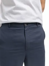 Pantalón de corte clásico confeccionado en mezcla de lino y viscosa, color negro. Presenta bolsillos laterales, bolsillos traseros con botón, cintura con pasadores y cordón interno de ajuste, y cierre frontal con cremallera y botón.