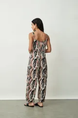 Mono largo de tirantes finos con estampado abstracto en tonos negro, marrón y blanco.