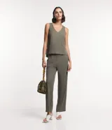 Musculosa verde oliva de piquet con escote en pico, breteles anchos, pequeñas aberturas laterales y bajos con pespuntes.