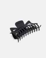 Broche negro grande para el pelo, con forma de mandíbula y dientes para sujetar el cabello.