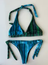 Conjunto de bikini con estampado de rayas en tonos azul y verde. El corpiño es de corte triangular con tirantes halter y la bombacha se ata a los costados.