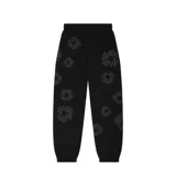 Pantalón de jogging negro con estampado de flores grises, corte holgado y cintura con cordón ajustable.