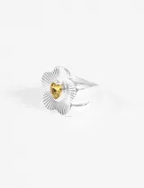 Anillo plateado con forma de flor y piedra amarilla en el centro.