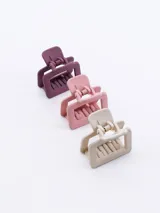 Set de tres pinzas para el pelo de plástico opaco en color lila, rosa y beige.