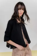 Saco tejido color negro con detalle en escote y puños a dos tonos, corte acampanado y detalle en la espalda con cambio de punto y color.