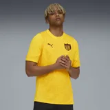 Camiseta de fútbol Puma del Club Atlético Peñarol, color amarillo con diseño geométrico en relieve. Presenta cuello redondo, logo de Puma bordado en el pecho y escudo del club.
