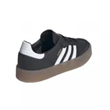 Zapatillas Adidas Samba con plataforma, color negro con las tres tiras blancas y suela marrón.