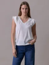 Remera blanca de modal con escote en V y detalle de puntilla en mangas y escote.