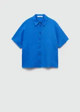 Camisa blanca de lino con cuello clásico, manga corta y cierre frontal con botones.