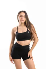 Top deportivo color lila con tirantes finos y espalda cruzada.