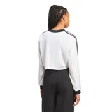 Remera corta blanca de mangas largas con cuello en V y tres tiras negras en los hombros.