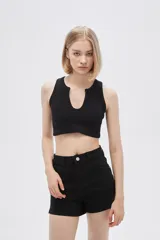 Top negro de bretel ancho, confeccionado en poliamida con textura acanalada. Diseño al cuerpo con escote profundo en forma de U.