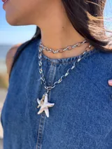 Collar doble con cadena de eslabones plateados y dije de estrella de mar.