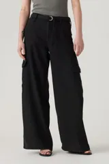 Pantalón cargo negro de corte ancho, con bolsillos laterales con solapa y cintura con cinturón ajustable con hebilla metálica.