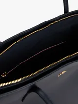 Cartera tote Tommy Hilfiger color azul marino, con doble asa superior y cierre de cremallera. Presenta el logo metálico de la marca en dorado en el frente.