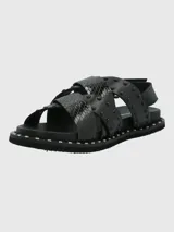Sandalias negras de cuero con tiras cruzadas y tachas plateadas.