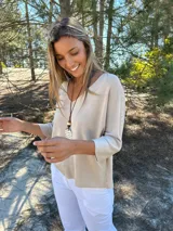 Sweater beige de algodón con escote en V y mangas ranglan.