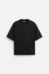 Sudadera negra de corte relaxed fit, confeccionada en tejido interlock de algodón con elasticidad. Tiene cuello redondo, manga corta y bajo acabado en rib.