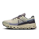 Championes de trail running color crema, con detalles en gris, azul y violeta.